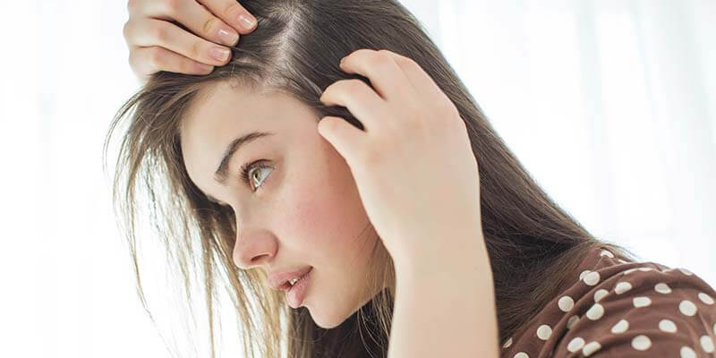 girl inspecting scalp