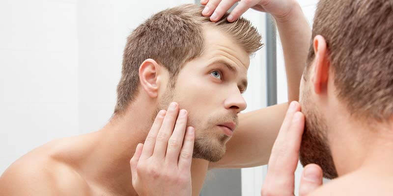 male checking hair loss