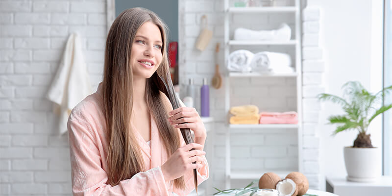 woman applying hair treatment