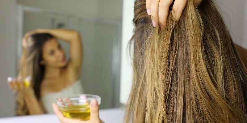 applying oil to scalp